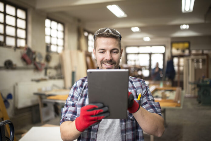 Creative worker carpenter looking for new ideas in workshop. what a business broker does